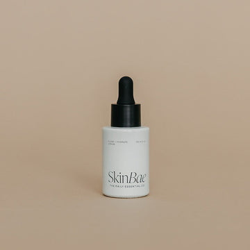 Skincare dropper bottle with 'SkinBar' branding on a beige background