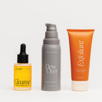 Three skincare products labeled 'Cleanse', 'Dew Over', and 'Exfoliant' on a white background.